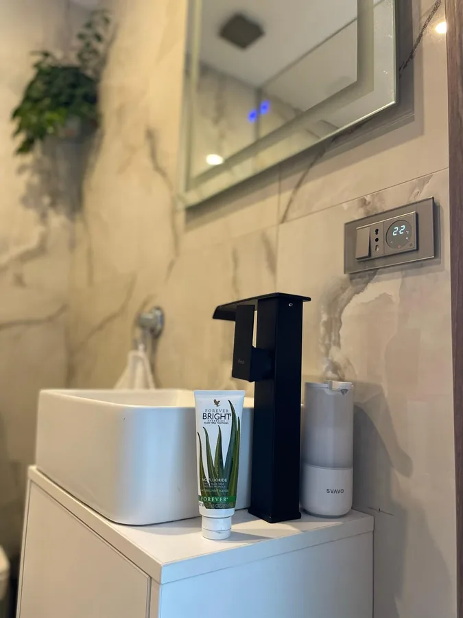 Bathroom counter with black faucet and included care products